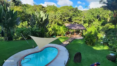 an aerial view of a backyard with a swimming pool and a gazebo at YETHAN HOUSE in Uvita