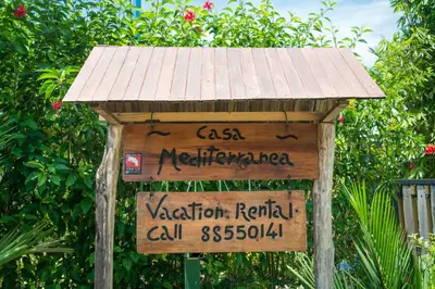 a wooden sign with a roof on top of it at Uvita Oasis Retreat with Villa Apt Bungalows Cabin in Uvita