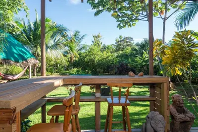 a wooden table and chairs in a garden at Uvita Oasis Retreat with Villa Apt Bungalows Cabin in Uvita