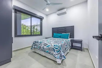 a bedroom with a bed and a window at Casamar Villa's in Uvita