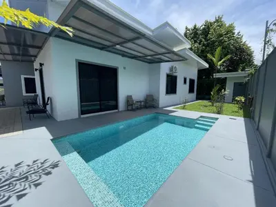 a swimming pool in the backyard of a house at Casamar Villa's in Uvita