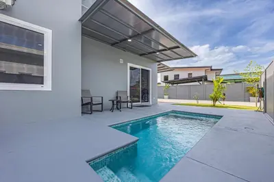 a swimming pool in the backyard of a house at Casamar Villa's in Uvita