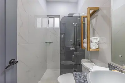 a bathroom with two sinks and a shower at Casamar Villa's in Uvita