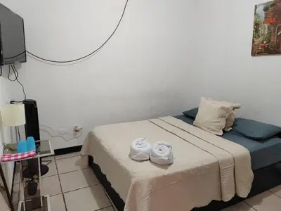 a bedroom with a bed with towels on it at Gran Hotel Desamparados in Desamparados