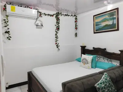 a bedroom with a bed and a couch at Gran Hotel Desamparados in Desamparados
