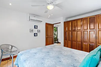 a bedroom with a bed and a chair in it at Inviting Home with Colorful Decor and Private Backyard Oasis with a Swimming Pool & Shaded Terrace in Santa Cruz