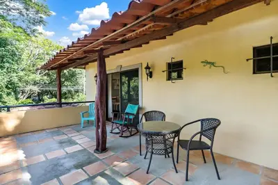a patio with a table and chairs on it at Inviting Home with Colorful Decor and Private Backyard Oasis with a Swimming Pool & Shaded Terrace in Santa Cruz