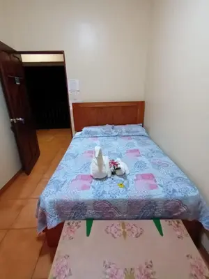 a bed with two stuffed animals sitting on it at YETHAN HOUSE in Uvita