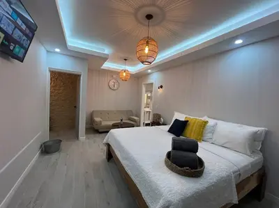 a bedroom with a large bed and a living room at Luxury Villa and Bungalows in Fortuna