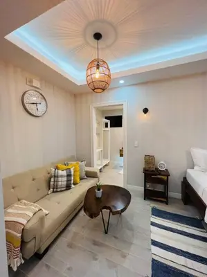 a living room with a couch and a clock on the ceiling at Luxury Villa and Bungalows in Fortuna