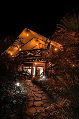 a building at night with lights on a stone path at Luxury Villa and Bungalows in Fortuna