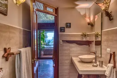 a bathroom with a sink and a mirror at Hotel Amor de Mar in Montezuma