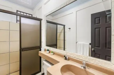 a bathroom with a sink and a large mirror at Stunning Gated Property with a Lush Garden, Wrap-Around Terrace & Private Pool in Potrero