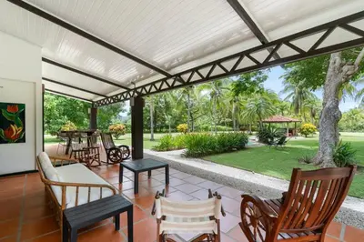 an outdoor patio with chairs and tables and a pergola at Stunning Gated Property with a Lush Garden, Wrap-Around Terrace & Private Pool in Potrero