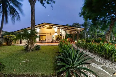a house with a garden in front of it at Stunning Gated Property with a Lush Garden, Wrap-Around Terrace & Private Pool in Potrero