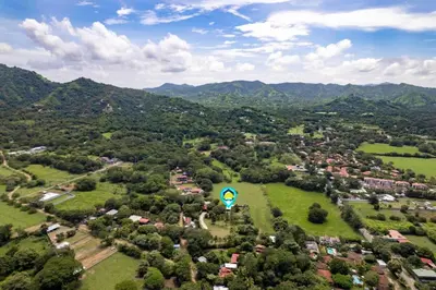 an aerial view of a small town in a green field at Stunning Gated Property with a Lush Garden, Wrap-Around Terrace & Private Pool in Potrero