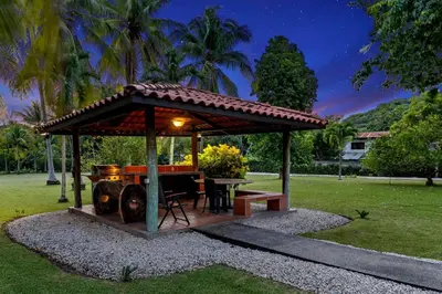 a gazebo with a table and a grill at Stunning Gated Property with a Lush Garden, Wrap-Around Terrace & Private Pool in Potrero