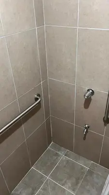 a shower stall with a glass door and a tiled shower at Bungalows Paraíso Celeste in Bijagua