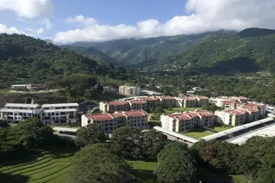 an aerial view of a campus with mountains in the background at CR MARIPOSA RENTALS Comfortable penthouse, AC, pool, gym, tennis in Santa Ana