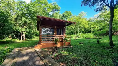 a small cabin in the middle of a field at Hotel Hacienda Angeles in Paraíso