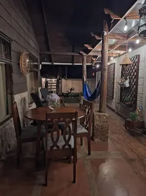 a dining room with a wooden table and chairs at Preciosa cabaña en Fraijanes in Fraijanes