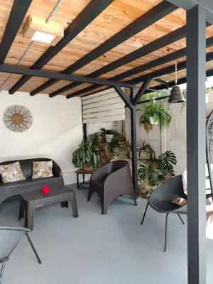a patio with furniture and a wooden ceiling at Preciosa cabaña en Fraijanes in Fraijanes