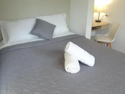 a roll of toilet paper sitting on a bed at Airport Green Studio in Santiago Este