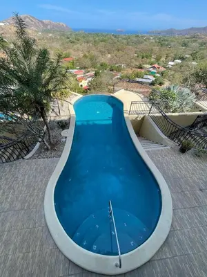 a large swimming pool in the middle of a resort at Seaside Serenity 2b2b with Panoramic Terrace in Coco