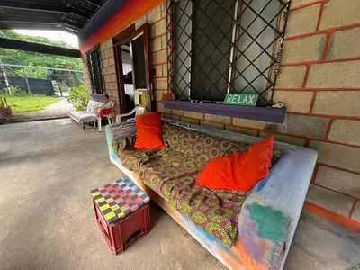 a bed sitting outside of a building with at Passiflora Backpackers Samara in Sámara
