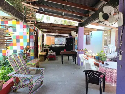 a room with chairs and a table in a room at Passiflora Backpackers Samara in Sámara
