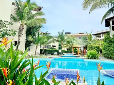 a pool at a resort with palm trees at The Castaway in Coco