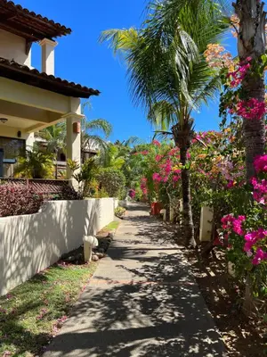 a walkway in front of a house with flowers at The Castaway in Coco