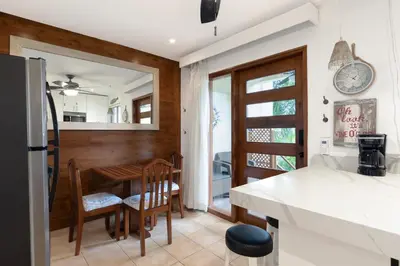 a kitchen and dining room with a table and chairs at The Castaway in Coco
