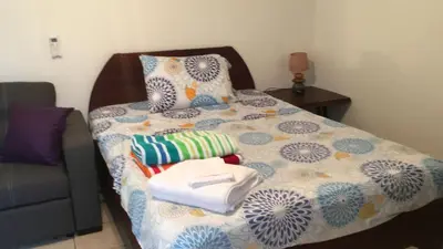 a bedroom with a bed with a blue and white quilt at Casa Flores Carrillo - Monkey Cabena in Carrillo