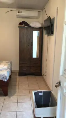 a room with a sink and a cabinet and a television at Casa Flores Carrillo - Monkey Cabena in Carrillo