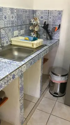 a kitchen counter with a sink and a trash can at Casa Flores Carrillo - Monkey Cabena in Carrillo