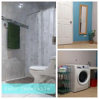 a bathroom with a shower and a toilet and a washing machine at Villa Chungos in Quebrada Ganado