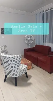 a living room with a couch and a chair at Villa Chungos in Quebrada Ganado