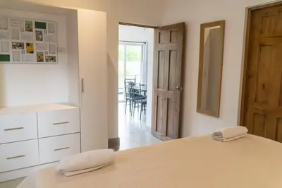 a bedroom with a bed with two towels on top of it at Condominios Akira in Tamarindo