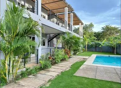 an exterior view of a house with a swimming pool at Condominios Akira in Tamarindo
