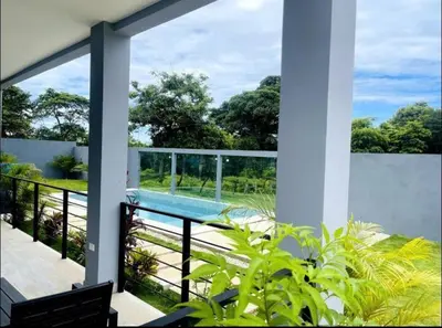 a view of a swimming pool from the balcony of a house at Condominios Akira in Tamarindo