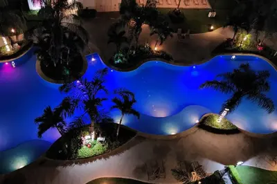 an overhead view of a swimming pool at night at Jaco Bay Condo with Great Views! in Jacó