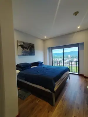 a bedroom with a large bed and a large window at Jaco Bay Condo with Great Views! in Jacó