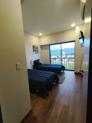 a bedroom with two beds and a large window at Jaco Bay Condo with Great Views! in Jacó