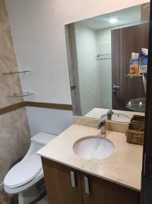 a bathroom with a sink and a toilet and a mirror at Jaco Bay Condo with Great Views! in Jacó