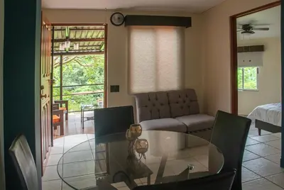 a living room with a glass table and a couch at Organic Garden in San José