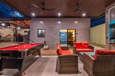 a billiard room with a pool table and chairs at La Casa de Papi. in Parrita
