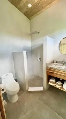 a bathroom with a toilet and a sink at Sharma Costa Rica- Mimosa Casita in Uvita