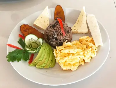 a plate of food with different types of food on it at Tico Bed & Breakfast La Fortuna in Fortuna