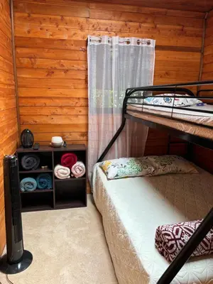a bedroom with two bunk beds in a cabin at Chalet El Riachuelo in La Suiza